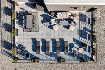A top-down view of a courtyard with a table and chairs.